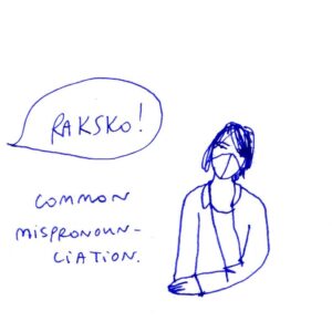 Diary comics, panel 3/4. Julia is sitting with her head tilted, and looking at the speech bubble that says 'Raksko!' Caption: Common mispronounciation.